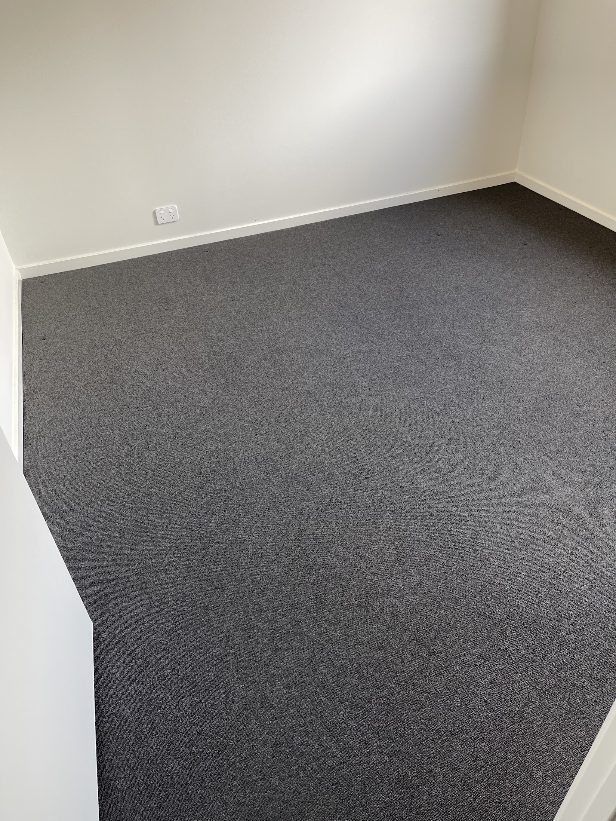 Freshly cleaned charcoal carpet in an empty bedroom