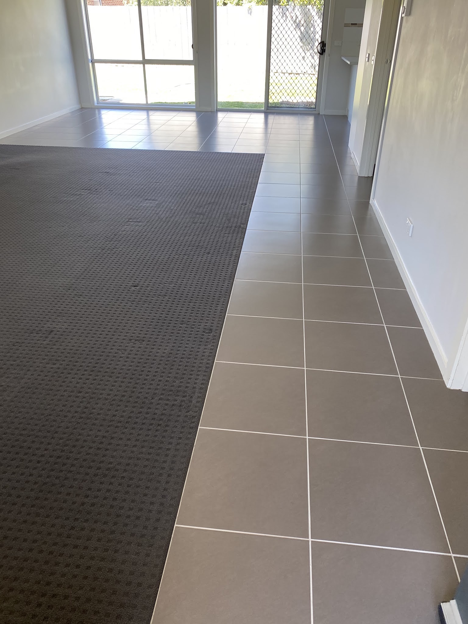 Cleaned carpet meeting a tiled hallway after an end-of-lease clean